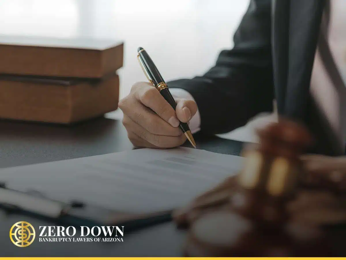 Zero Down Bankruptcy Lawyers of Arizona attorney signing documents at a desk, with a gavel visible, symbolizing legal authority and procedure