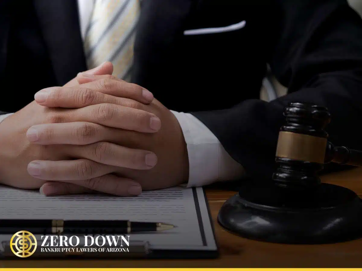 Close-up of a lawyer's hands folded on a desk with a gavel, representing legal support for layoffs in Las Vegas